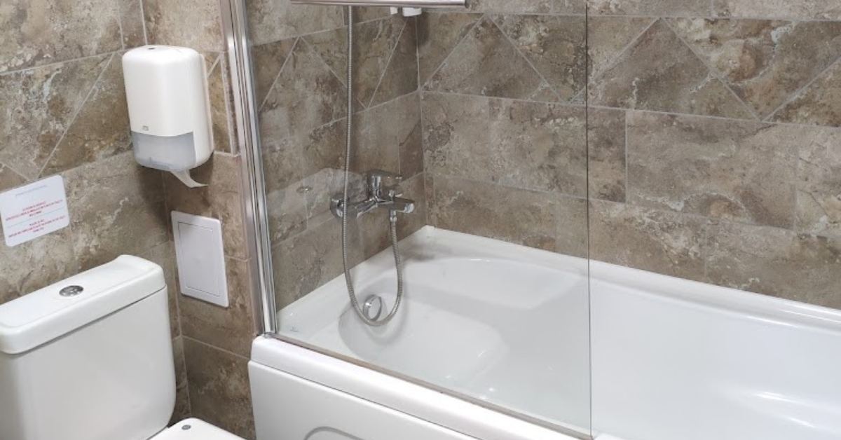 Bathroom with bathtub and shower cabin